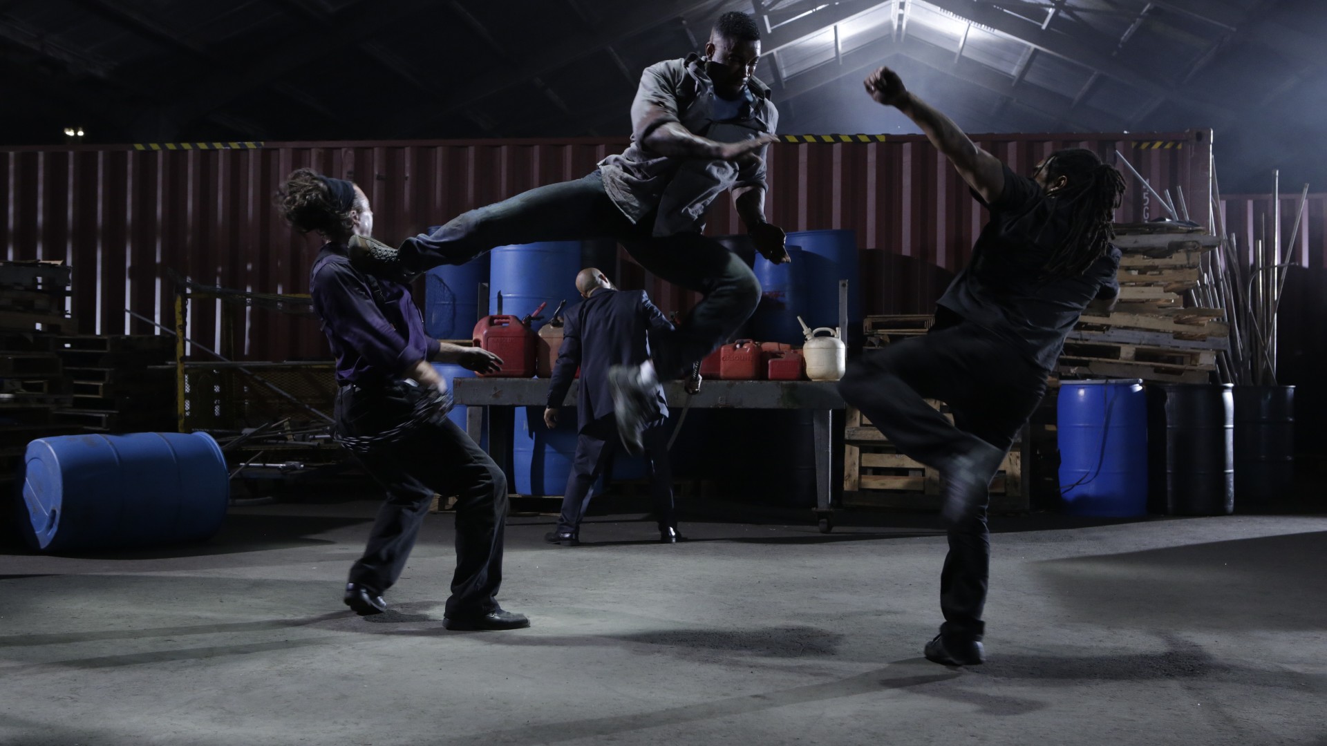 Michael Jai White airborne in a flying kick during an action demonstration